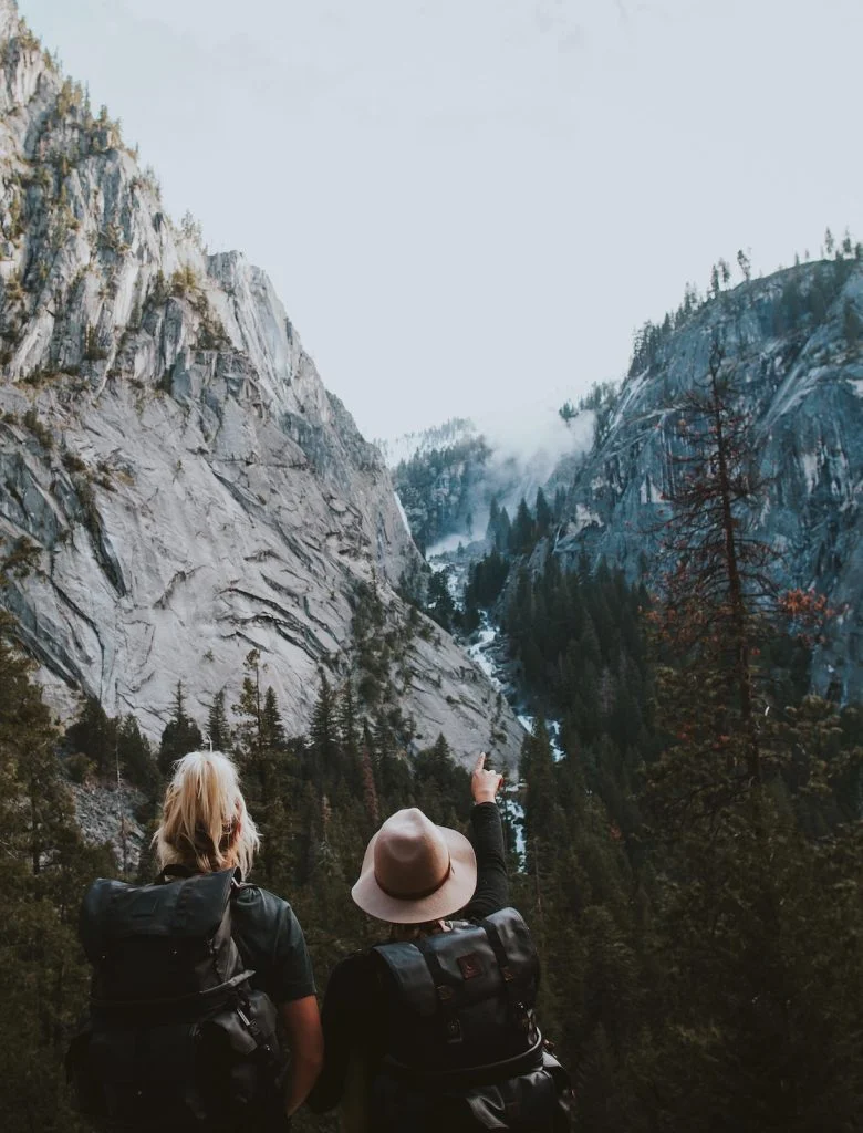 Two human standing between the mountains